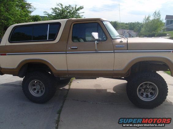 Two-tone brown 1978 Ford Bronco lifted on off-road tires, seen from the side