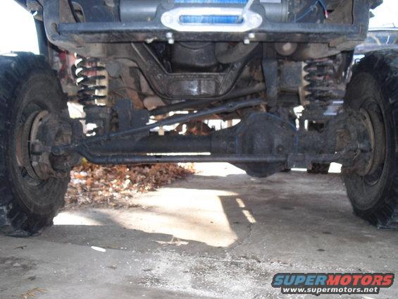 Undercarriage view of a 4x4 with large tires and suspension components