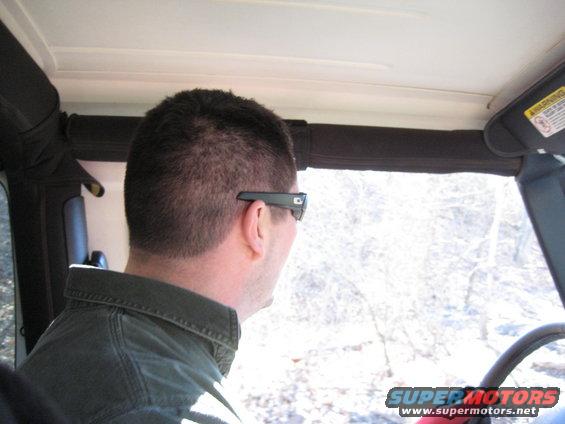 Interior view of a 2005 Jeep Wrangler with driver wearing sunglasses