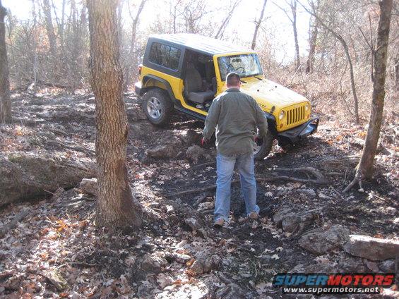 Yellow 2005 Jeep Wrangler on a rocky trail