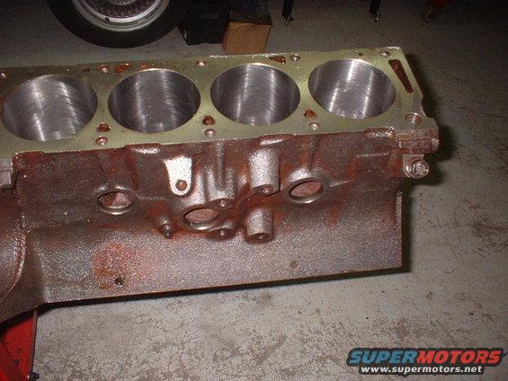 Engine block with four cylinders visible. Some rust on the exterior