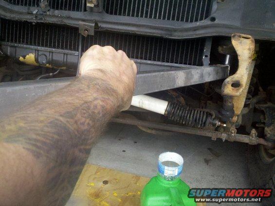 20120115_110112_853.jpg Breaker bar got it loose, but it was lifting the radiator clip off of the frame rail as I twisted the nut?  Seems stuck on there.