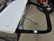 1987 Dodge 1500 - Car door with black trim is mounted on a stand for painting.