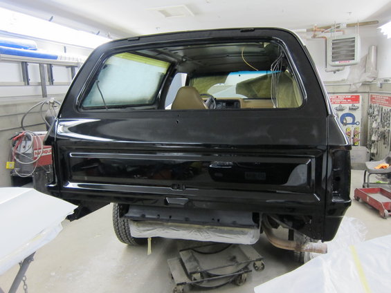 Black SUV rear view, undergoing bodywork
