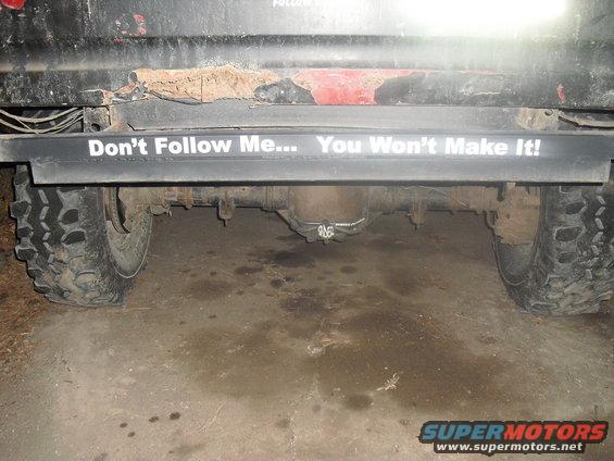Rear axle and tire of a truck with a "Don't Follow Me... You Won't Make It!" sticker