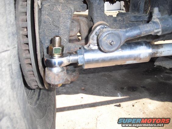 Close-up of vehicle steering linkage and tire