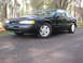 1997 Ford Thunderbird - A black Ford Thunderbird is shown from the front-three-quarter view, parked outdoors on a paved surface.