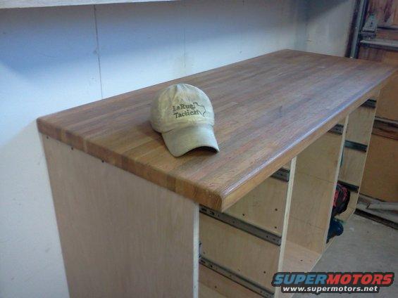 Workbench with a tan baseball cap that has 'LaRue Tactical' text