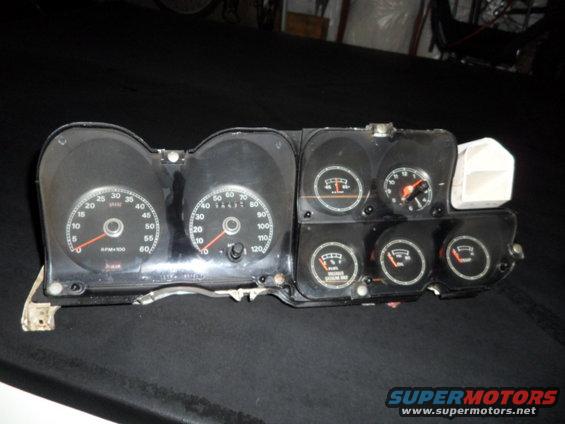 Car dashboard instrument cluster with speedometer, tachometer, fuel gauge, and oil pressure gauge