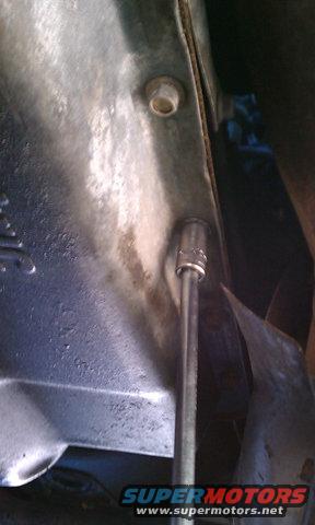 Pull the bolts from your transmission pan. I usually start by taking the ones completely out across the front, then drop the ones down the sides a little and slide a container under it to catch the fluid. Then start removing the ones across the back of the pan. This is when the fluid usually start to come out from the front where the bolts are completely removed. Then I slowly remove the bolts along the sides starting from the front, letting it drain. This kind of keeps the fluid from coming out from all sides.