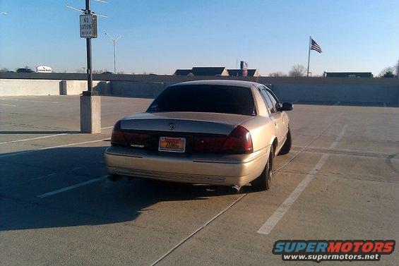 Rear view of a gold Mercury Grand Marquis parked in a lot. License plate reads ZORG