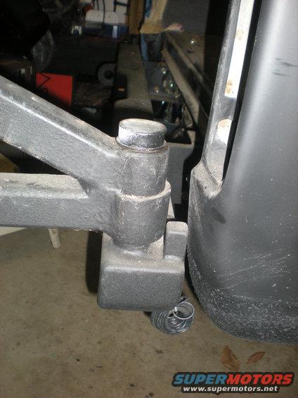 Trailer hitch assembly attached to a black bumper