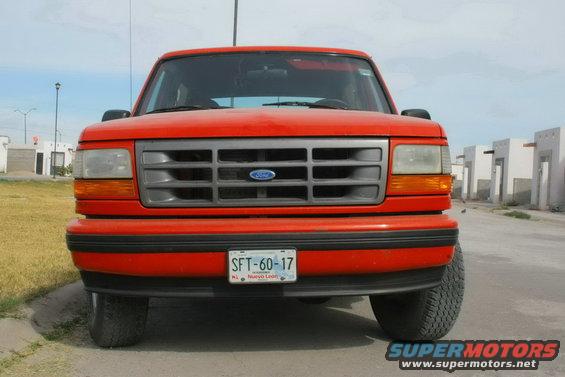 Front view of a red Ford Bronco with a gray grille and a license plate reading SFT-60-17