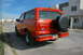 1995 Ford Bronco - Rear view of a red 1995 Ford Bronco parked on a residential street.