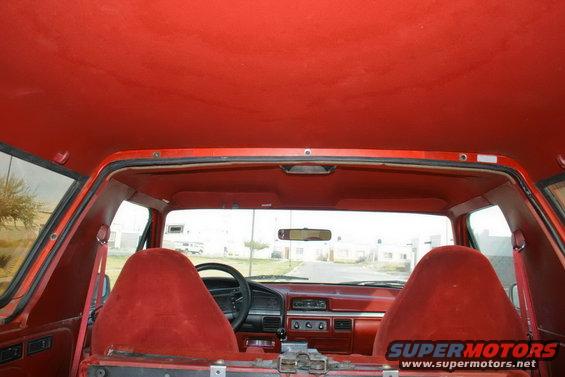 1995 Ford Bronco interior, red seats and headliner, view through windshield