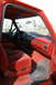 1995 Ford Bronco - The interior of a 1995 Ford Bronco features red upholstery and dashboard accents.