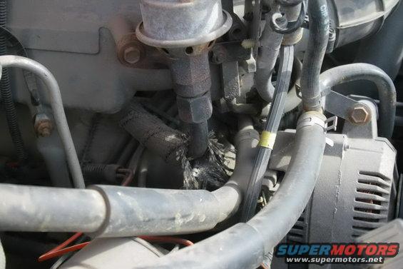 close-up of engine bay with hoses and alternator