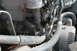 1995 Ford Bronco - A close-up view of engine components, including hoses and an alternator, is shown.