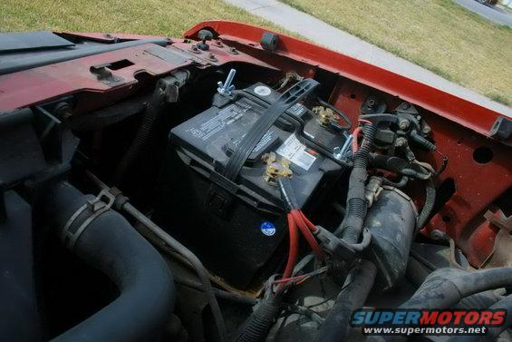 Engine bay with battery and red fender