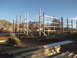 1995 Ford Bronco - A wooden frame building is under construction on a sunny day, with mountains in the background.