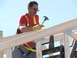 1995 Ford Bronco - A worker hammers wooden beams while wearing a safety harness against a clear blue sky.
