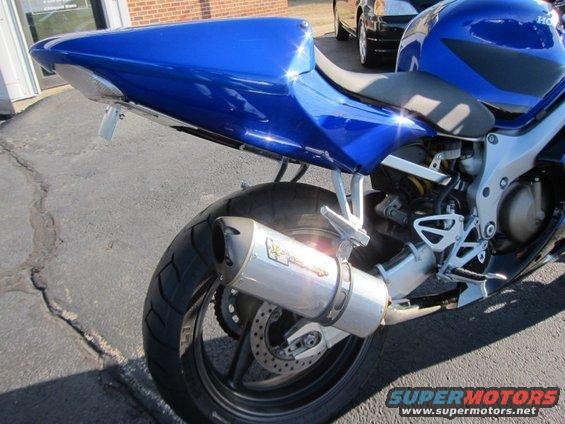 Blue sport motorcycle rear with aftermarket exhaust and license plate bracket