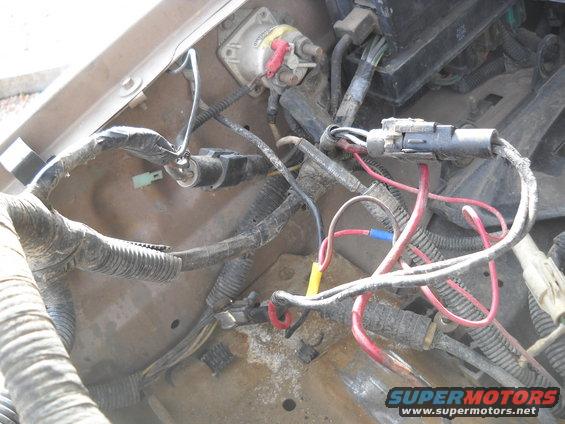Engine wiring harness with red, yellow, and blue connectors, and a white solenoid