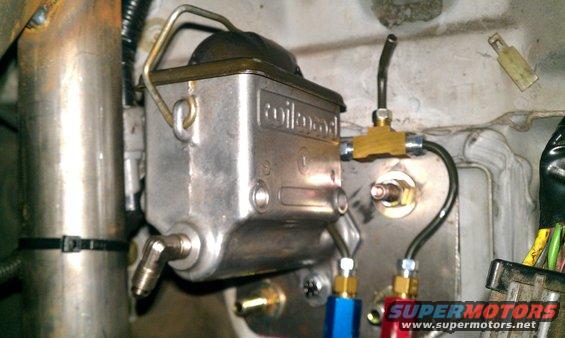 Close-up of a Wilwood master cylinder with brake lines connected