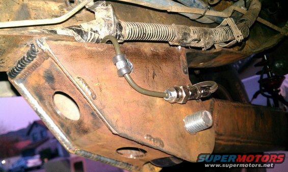 Custom bracket with brake line fitting welded to vehicle frame