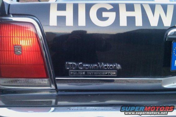 Rear of a black Ford LTD Crown Victoria Police Interceptor with "HIGHWAY" text on the trunk lid
