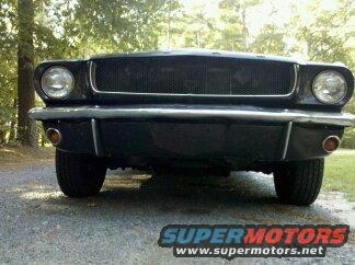 Black 1965 Ford Mustang front view. Grille and headlights visible
