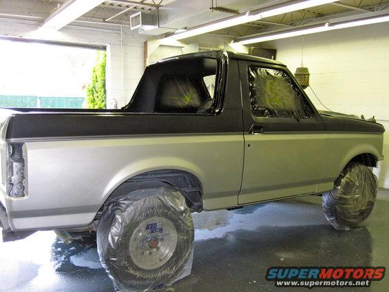 1992 Ford Bronco side view, silver and black two-tone paint, wheels covered