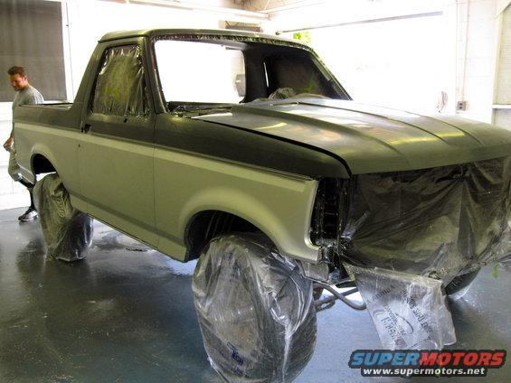 1992 Ford Bronco with plastic sheeting on wheels and front end, ready for paint