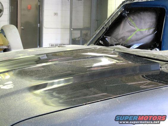 Hood scoop on a vehicle undergoing repair