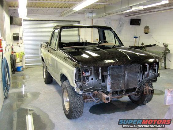 1992 Ford Bronco with front end disassembled in a garage