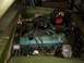 1971 Dodge Dart - The engine bay of a 1971 Dodge Dart, a jump starter connected to the battery.