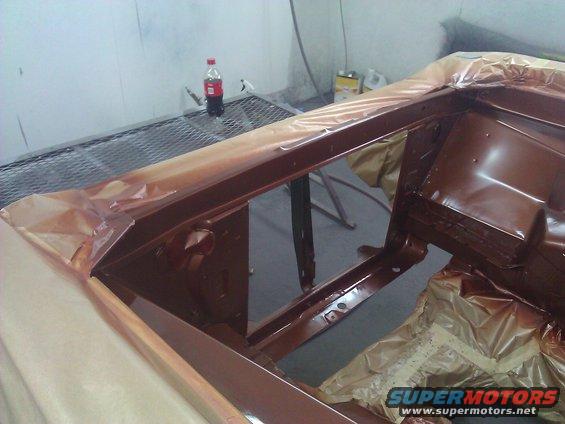 Car frame with brown paint and masking tape