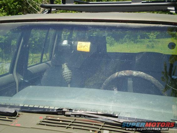 1992 Jeep Cherokee interior showing dashboard with grenade and yellow "Say" sticker on windshield