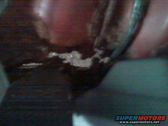 Close-up of dark brown interior trim with some white debris