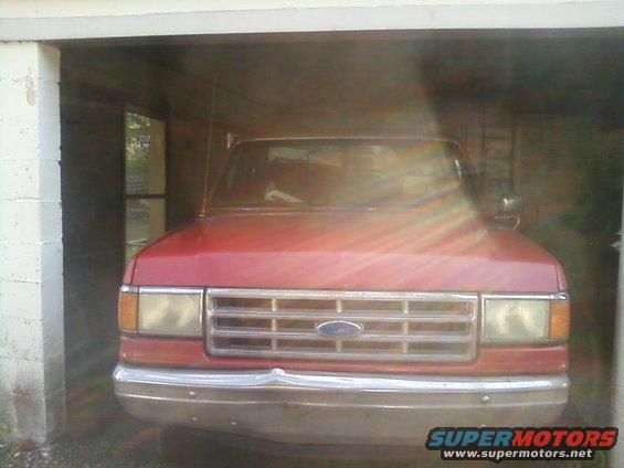 Red 1988 Ford F-150 front view in garage