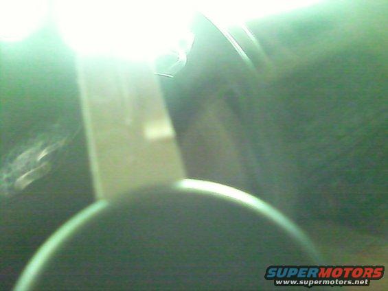 Interior shot of a vehicle part, possibly a dashboard component, with bright light