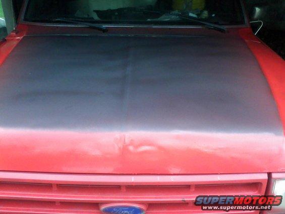 Red 1988 Ford F-150 front view with matte black hood