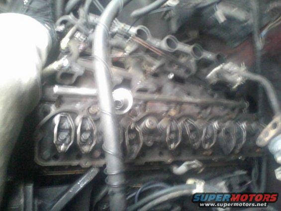 Close-up of engine valve train with visible rocker arms and springs