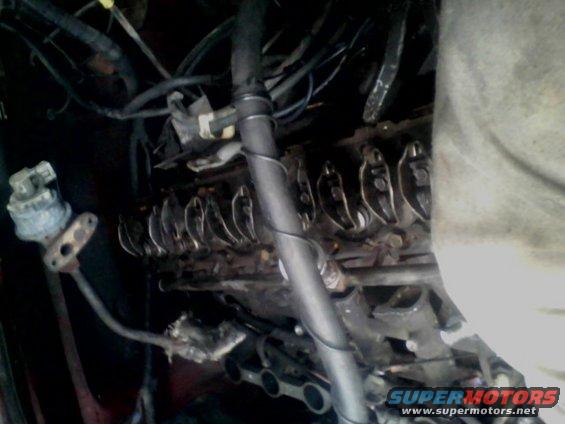 Engine valve train with rocker arms and pushrods visible