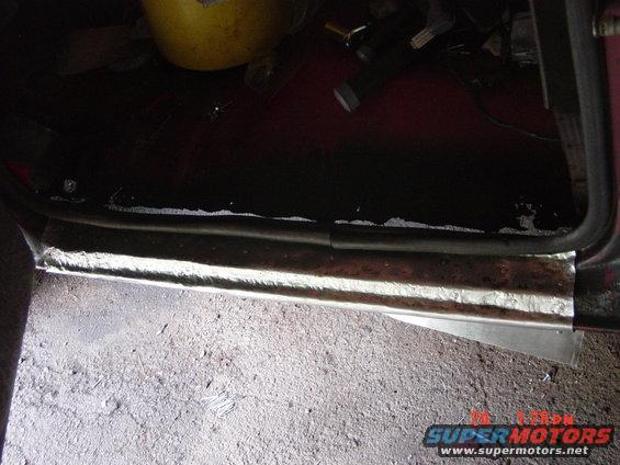rusted rocker panel being repaired with metal patch