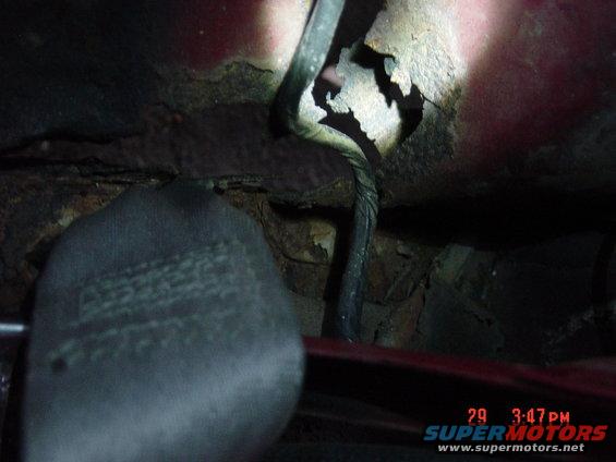 rusted metal with wiring harness and seatbelt buckle