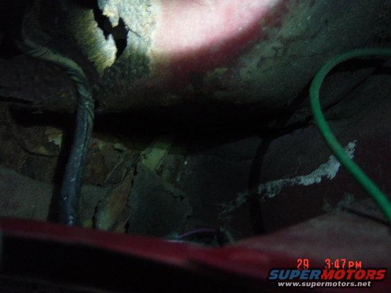 Rusted metal and wiring under a red vehicle part. Timestamp 29 3:47 PM