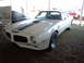 1982 Chevrolet Camaro - This 1970 Pontiac Firebird is displayed outdoors with other vehicles nearby.
