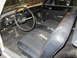 1964 Ford Ranchero - The interior of the vehicle shows signs of wear, including a torn driver's seat and a dated dashboard.