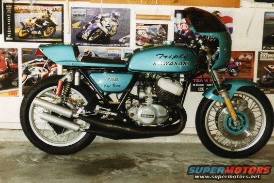 Teal Kawasaki 750 Cafe Racer motorcycle with dual exhaust and spoked wheels